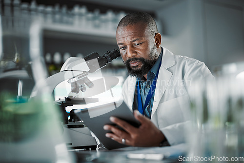 Image of Black man thinking, science and tablet for online research, laboratory and healthcare sample. African American male, scientist or research in lab, digital data and update experiment results and focus