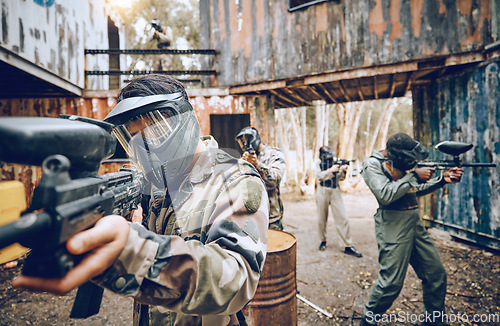 Image of Paintball gun, team building and soldier group together for military, army and field training. Exercise, fitness and target shooting of a man with battlefield players in sport event with focus