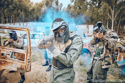 Image of Teamwork, paintball and sports with people in field for hero, target and shooting games. War, smoke and community with man gamer playing in camouflage for military, army and competition training