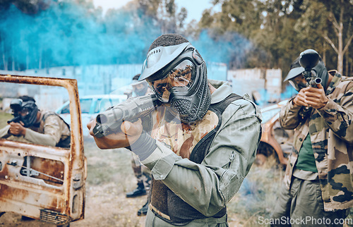 Image of Paintball, teamwork and shooting with people in field for sports, target and fitness games. War, smoke and community with man gamer playing in camouflage for military, army and competition training