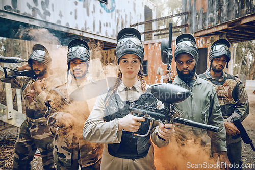 Image of Paintball gun, woman portrait and leader in smoke for a sports game, competition or challenge. Diversity men and strong warrior team for military, soldier or army fight outdoor in war battlefield