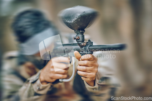 Image of Paintball, gun and target with man, action and sports outdoor, battlefield and soldier, focus during war game. Extreme sport, aim weapon and military mission, exercise and fitness with motion blur