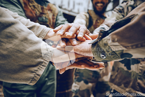 Image of Soldier, team building or hands in a huddle for a mission, strategy or motivation on a paintball battlefield. Goals, collaboration or army people with support in a partnership or military group