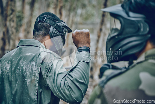 Image of Hand sign, man and paintball training by friends for planning, strategy and plan of action outdoor. Military, men and fist of guy leading team in sports, shooting and intense target practice together