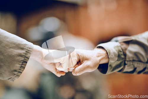 Image of Hands, soldier and fist bump for partnership, deal or agreement in collaboration or trust together. Hand of army people touching fists in support for friendship, community or unity in solidarity