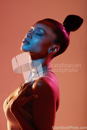 Image of Beauty aesthetic, cosmetics and face of woman in neon studio with makeup, designer jewellery and style. Fashion model, pink lighting and Latino girl with glamour, luxury accessories and glowing skin