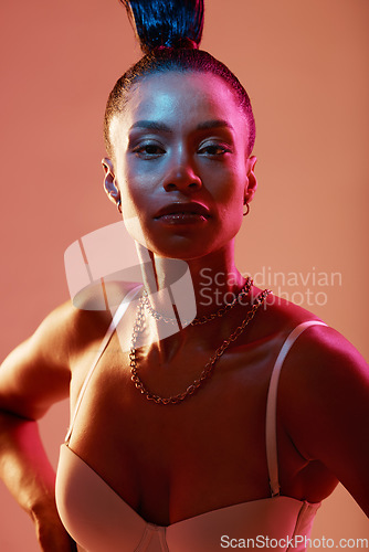 Image of Portrait, beauty and neon with a model black woman in studio on a kaleidoscope background for fashion. Art, makeup and style with an attractive young female posing indoor for culture or cosmetics