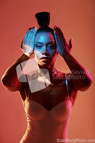 Image of Portrait, fashion and neon with a model black woman in studio on a kaleidoscope background for beauty. Art, makeup and style with an attractive young female posing indoor for culture or cosmetics