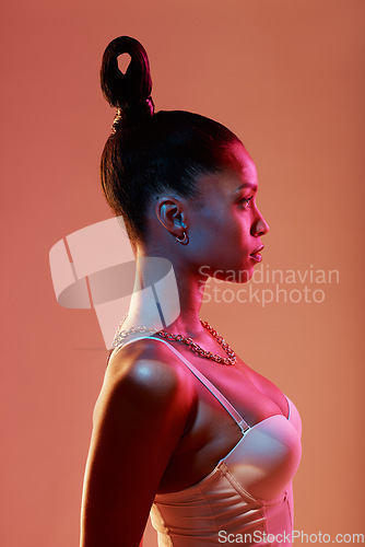 Image of Beauty aesthetic, fashion and profile of woman in neon studio with makeup, designer jewelry and cosmetics. Creative style, pink lighting and Latino girl with glamour, luxury lingerie and glowing skin