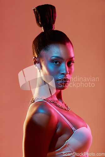 Image of Neon lighting, fashion and portrait of a woman with makeup isolated on a brown studio background. Cyberpunk, futuristic and face of a model with creative beauty, color and glow on a backdrop