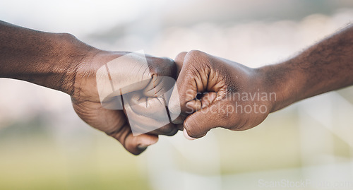 Image of Fist bump, closeup and hands celebrating as teamwork on sports field winning and power of working together. Team, support and unity of teammates in collaboration or partnership with motivation