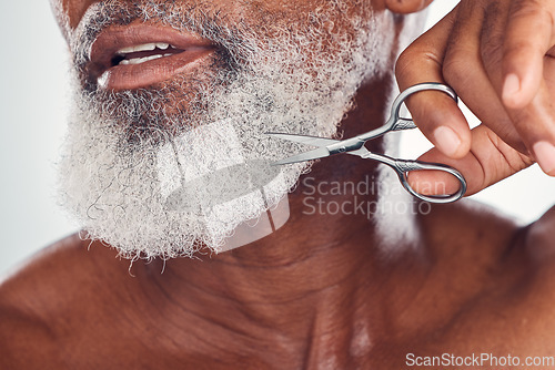 Image of Trimming, beard and face of a man with a scissors isolated on a white background in a studio. Zoom, hygiene and elderly person cutting facial hair, cleaning and grooming for a treatment on a backdrop