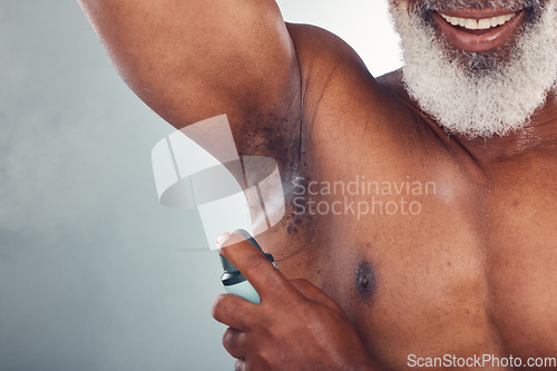 Image of Old man, spray armpit with skin and smile for beauty, grooming and hygiene isolated on studio background. Happiness, wellness and skincare, cosmetic product and topless with deodorant and fragrance