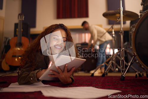 Image of Song writer, digital tablet and woman with idea for music, sound and composition in studio, happy and smile. Female, artist and composer online for creative, planning and audio, track and production