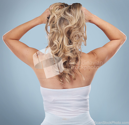 Image of Back, hair care and beauty of woman in studio isolated on a gray background. Keratin, cosmetics and female model with curly hairstyle after salon treatment for growth, texture or blonde balayage.
