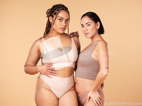 Image of Confidence, empowerment and portrait of women in underwear isolated on a studio background. Sexy, support and models in lingerie for body positivity, comparison and acceptance on a beige backdrop