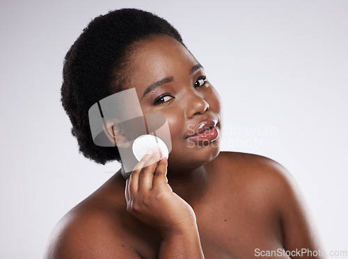 Image of Portrait, makeup and black woman with cotton pad, dermatology and girl on grey studio background. Face, African American female and lady with cosmetics, confidence and facial cleaning on backdrop