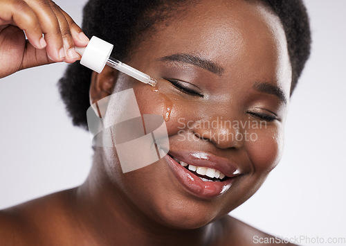 Image of Black woman, skincare serum and studio for cosmetic beauty, smile and happiness by background. Facial oil product, young african model and natural skin glow with hyaluronic acid detox for wellness