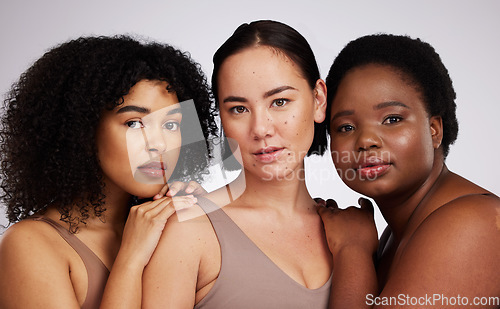 Image of Portrait, beauty and diversity with woman friends in studio on a gray background together for skincare. Face, makeup and natural with a female model group posing to promote support or inclusion