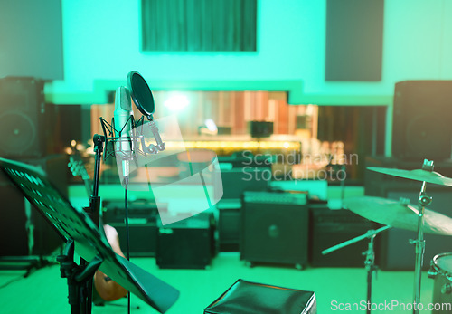 Image of Music, recording studio and interior with instruments for creative, musician or industry background. Audio technology, microphone and sound production for radio, media and electronics in neon lights