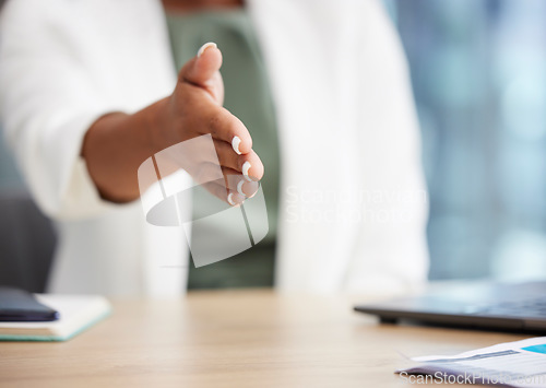 Image of Business woman with a handshake gesture in her office for welcome, onboarding or greeting. Corporate, career and African female employee shaking hand for partnership, deal or agreement in workplace.