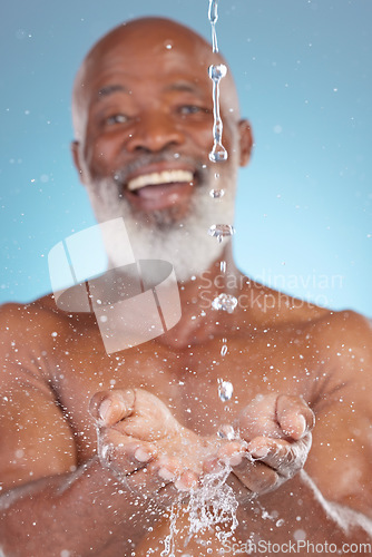 Image of Shower, catching and hands of a black man with water for sustainability isolated on a blue background. Smile, clean and senior African person saving liquid from washing in palm on a studio backdrop