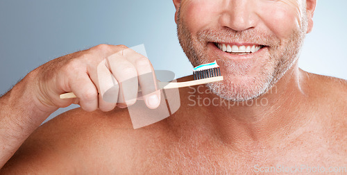 Image of Smile, mouth or hand brushing teeth with dental toothpaste for healthy oral hygiene grooming in studio. Eco friendly, happy or senior man cleaning gums or lips with a natural bamboo wood toothbrush