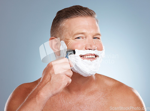 Image of Shaving, smile and portrait with cream and razor for face cleaning, wellness and skincare. Morning grooming, foam and model with facial care and skin treatment to shave hair in a studio isolated