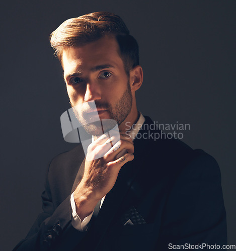 Image of Portrait, fashion and man in formal suit, trendy and elegant with confident guy on dark studio background. Face, male and entrepreneur with fancy outfit, trendy clothes and executive with aesthetic