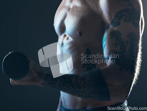 Image of Fitness, body and man with dumbbell in hand on blue background, isolated neon blue light and muscular chest. Sports, muscle and male model in artistic dark studio for power workout and gym aesthetic.