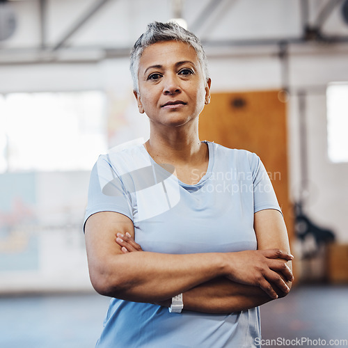 Image of Senior woman, fitness and portrait at gym after exercise, training or workout. Serious old person with arms crossed for health, wellness and motivation or commitment for healthy lifestyle goals