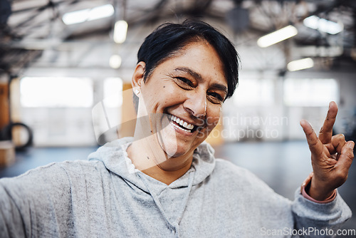 Image of Gym, fitness and selfie of old woman with peace sign, smile and motivation for exercise in Brazil. Workout, happy training and mature lady in profile picture for social media with emoji hand gesture.
