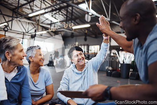 Image of Senior women, fitness and personal trainer high five for health, routine and workout at a gym. Exercise, elderly and friends with health coach man hands connecting in support of goal collaboration