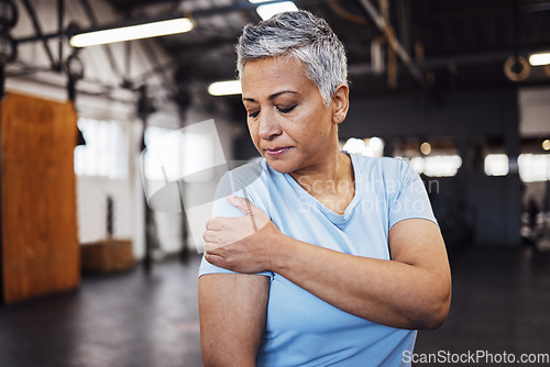 Image of Shoulder pain, fitness and senior woman at gym in training, workout or lose weight exercise with health risk. Injury, muscle and elderly person or athlete in sports burnout, arm accident or arthritis