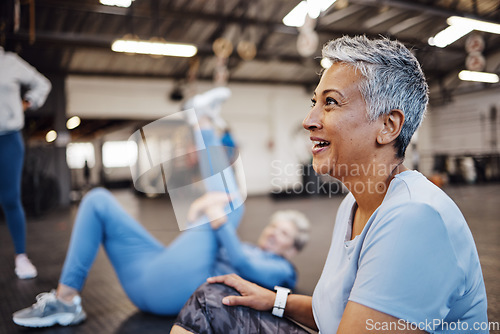 Image of Happy, fitness and senior woman at the gym for training, exercise and health in retirement. Break, tired and elderly person with a smile after a workout class, cardio or yoga with friends at a club