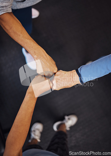 Image of Teamwork, top view and senior women fist bump for team building, motivation and unity. Support, collaboration and group of elderly friends huddle for trust, union or solidarity, goals or targets.