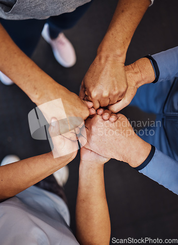 Image of Hands, teamwork and fitness with sports people standing in a huddle at gym from above for health. Collaboration, support and motivation with a man and woman athlete group in a circle for exercise