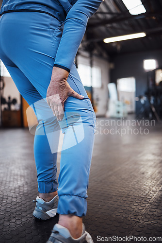 Image of Leg injury, accident and pain at a gym after workout, training or sport exercise with bruise. Fitness, sports and woman athlete limping from a swollen, inflammation or sprain muscle at a studio.