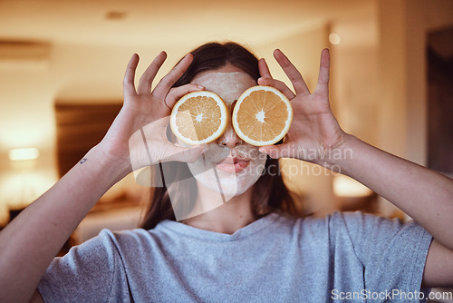 Image of Orange, eyes and skincare facial for woman in a bedroom, grooming and having fun with skin treatment. Face, mask and girl relax with fruit product, hygiene and beauty routine, with vitamin c at home