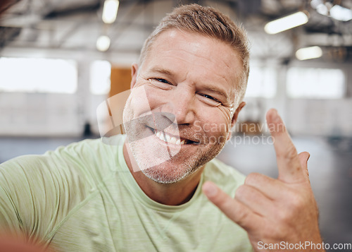 Image of Selfie, fitness and portrait of man in gym with rock hand sign for muscle, wellness and cardio workout. Smile, healthy body and face of senior male for bodybuilder training, exercise and sports goals