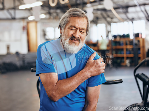 Image of Sports, gym and shoulder injury, old man in pain and emergency during workout at fitness studio. Health, wellness and inflammation, senior person with hand on muscle cramps while training in Japan.