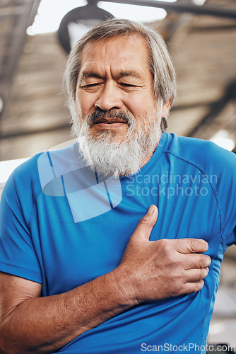 Image of Sports, gym and old man with pain in chest, medical emergency during workout at fitness studio. Exercise, health and wellness, stressed asian senior person with hand on heart while training in Japan.