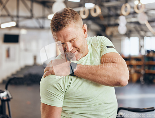 Image of Shoulder pain, training and bodybuilder man at gym for fitness, workout or challenge exercise in medical risk. Injury, muscle and strong person or athlete in sports burnout, arm accident or arthritis