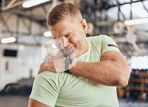 Image of Shoulder pain, fitness and bodybuilder man in gym for training, workout and challenge exercise with medical risk. Injury, muscle and strong person or athlete with sports burnout, arm or arthritis