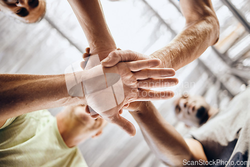 Image of Hands, stack and fitness huddle in workout gym, training exercise or healthcare wellness bonding. Low angle men, friends and motivation pile in sports teamwork, diversity support or mature community