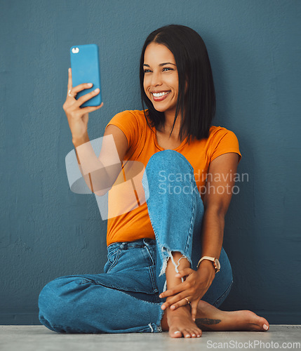 Image of Black woman, floor and home with smile for selfie fashion clothes or relax with beauty by wall background. Gen z girl, smartphone and happy in house with feet, jeans or face photo for profile picture