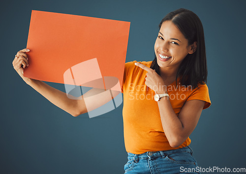 Image of Woman, poster or banner portrait with mockup space for sale, discount or promotion. Happy model pointing hand advertising product placement, logo or brand billboard on paper sign on blue background