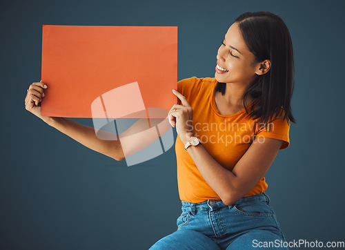 Image of Woman, poster and mockup banner space for sale, discount or promotion. Happy model with advertising for product placement, logo or branding on billboard orange paper sign in studio background