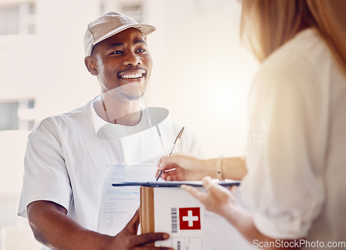 Image of Delivery, sign and man with a box for a customer for an online order or ecommerce shopping. Happy, smile and African courier driver giving a parcel or package to a woman for signage at her front door