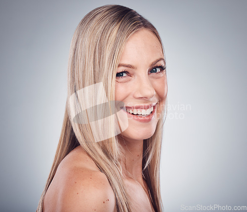 Image of Woman, portrait and face, smile with hair and beauty, hairstyle and cosmetic care isolated on studio background. Makeup, natural cosmetics and keratin treatment, dermatology and shine with skincare